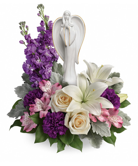 Angel sculpture surrounded by lavender, white and creme flowers and greenery